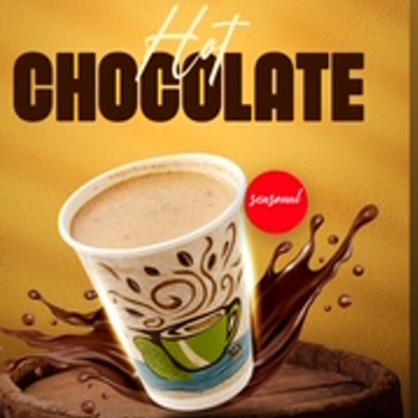 A seasonal hot chocolate in a decorative cup with chocolate splashes and the words "Hot Chocolate".